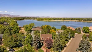 A large lake with houses and trees in the background.