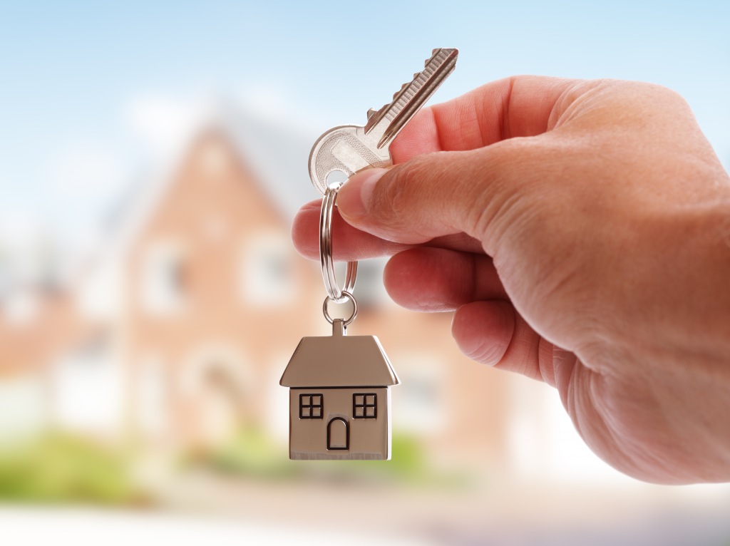 A person holding keys to a house